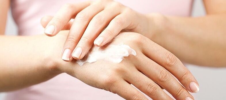applying cream on the skin of the hands